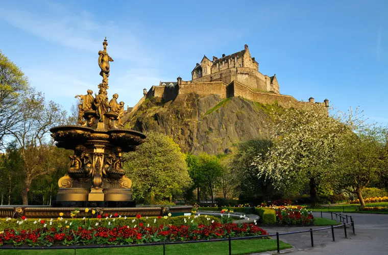 Edinburgh Castle on its rock above the Ross Fountain in Princes Street Gardens